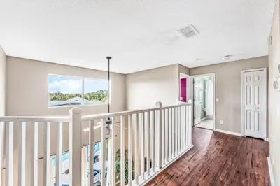 a staircase in a home with wood floors at Emerald Island Large 8 Bed Home Golf Resort villa in Kissimmee