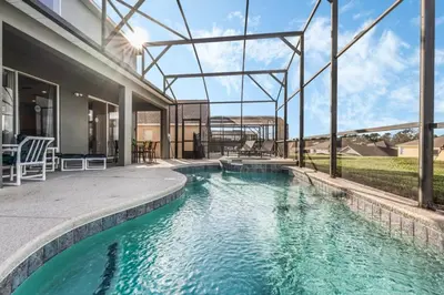 a swimming pool in the middle of a house at Emerald Island Large 8 Bed Home Golf Resort villa in Kissimmee