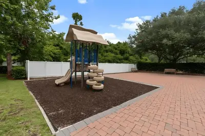 a playground with a slide and an umbrella at Casa 3Q West Lucaya – Perto da Disney c/ Clubhouse in Kissimmee
