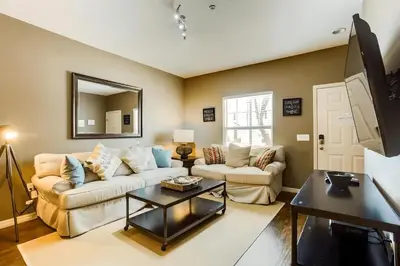 a living room with a couch and a table at Casa 3Q West Lucaya – Perto da Disney c/ Clubhouse in Kissimmee