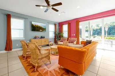 a living room with a couch and chairs at 5BD Moana-Themed - Movie by the Pool - Near Disney in Orlando