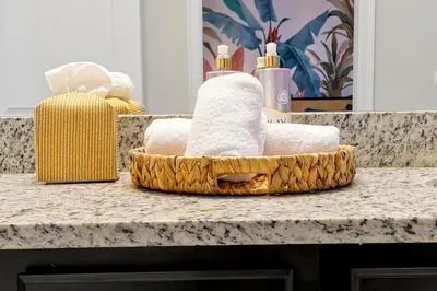 a basket of towels sitting on top of a counter at 5BD Moana-Themed - Movie by the Pool - Near Disney in Orlando