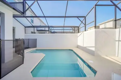 a swimming pool in a building with a glass ceiling at Luxury 4 Bedroom Storey Lake Townhome 2444Reading townhouse in Kissimmee