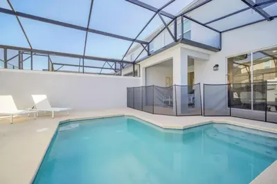 an indoor swimming pool with a large glass ceiling at Luxury 4 Bedroom Storey Lake Townhome 2444Reading townhouse in Kissimmee
