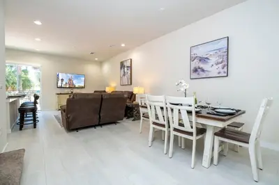a dining room and living room with a table and chairs at RCT Dreamstay in Orlando