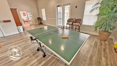 a ping pong table in the middle of a room at Deluxe 4 bedrooms Villa at Seven Dwrafs Resort - Close to Disney in Kissimmee