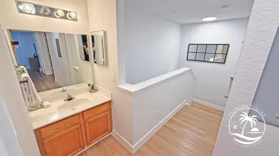 a bathroom with a sink and a mirror at Deluxe 4 bedrooms Villa at Seven Dwrafs Resort - Close to Disney in Kissimmee