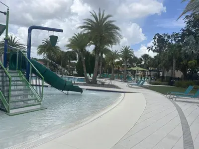 a water park with a slide in the water at 299- Fabulous 4 Bed Modern Decor Villa with Private Pool Overlooking Conservation and Water View in Kissimmee
