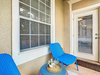 a blue chairs and a table in front of a window at Windsor Hills Cozy 3 BR Condo, Starwars, By Disney in Orlando