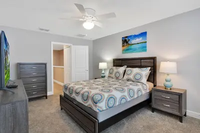 a bedroom with a bed and a ceiling fan at Spectacular! Townhome 9 Miles to Disney World! in Kissimmee