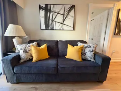 a blue couch with yellow pillows in a living room at 29-Universal, International Dr,Convention Center in Orlando