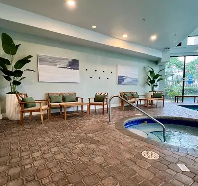 a lobby with a pool and chairs and a table at 14-Near Universal Studios Amazing View in Orlando