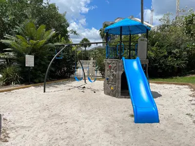 a playground with a blue slide in the sand at 14-Near Universal Studios Amazing View in Orlando