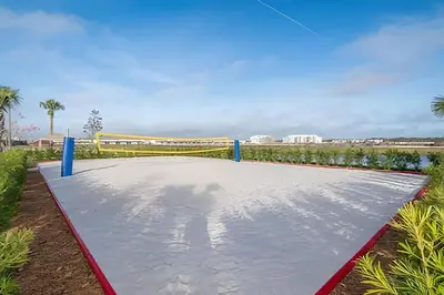 a volleyball court in a park with a soccer goal at Casa 7Q perto da Disney com Piscina e Games in Kissimmee