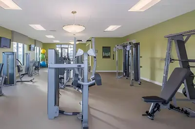 a gym with treadmills and elliptical machines at Casa 7Q perto da Disney com Piscina e Games in Kissimmee