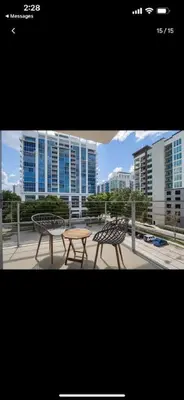 two chairs and a table in front of a building at Extra Large 1 Bdrm Condo & Gym in Orlando