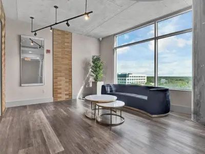 a living room with a couch and a table at Extra Large 1 Bdrm Condo & Gym in Orlando