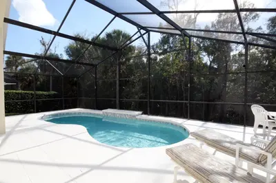 a swimming pool with a pergola and a patio at Cumbrian Retreat in Kissimmee