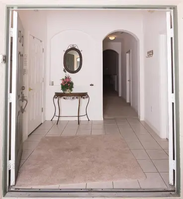 a hallway with a table and a mirror at Cumbrian Retreat in Kissimmee