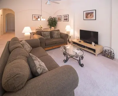 a living room with a couch and a tv at Cumbrian Retreat in Kissimmee
