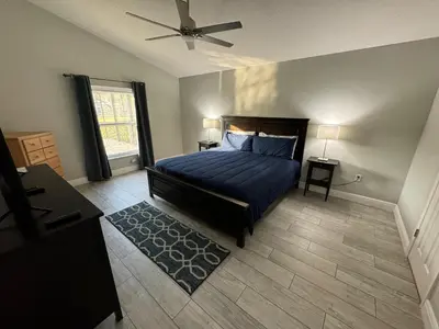a bedroom with a bed and a ceiling fan at Casablanca Villa in Kissimmee