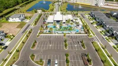 an aerial view of a parking lot with a pool at Brand New 12-bedroom Amazing house 5869 in Orlando