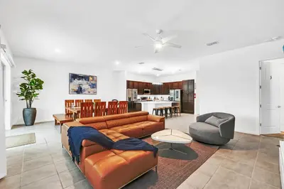 a living room with a couch and a table at Spacious Dreamscape 12rooms 11 bathrooms 25 people Wifi in Kissimmee