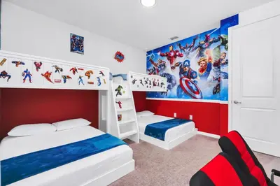 a bedroom with two bunk beds and a superhero mural at Spacious Dreamscape 12rooms 11 bathrooms 25 people Wifi in Kissimmee