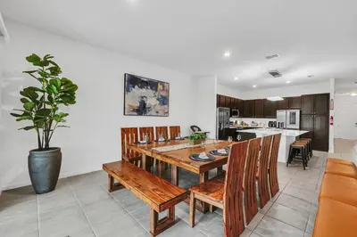 a kitchen with a wooden table and chairs at Spacious Dreamscape 12rooms 11 bathrooms 25 people Wifi in Kissimmee