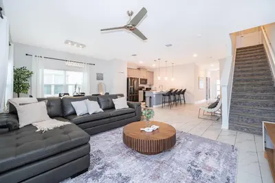 a living room with a couch and a table at Epic Elegance Home Resort Amenities Disney10 miles in Kissimmee