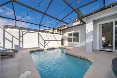 a swimming pool in the backyard of a house at Epic Elegance Home Resort Amenities Disney10 miles in Kissimmee