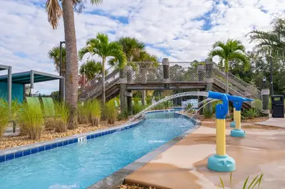 a pool with a water slide in a resort at Epic Elegance Home Resort Amenities Disney10 miles in Kissimmee