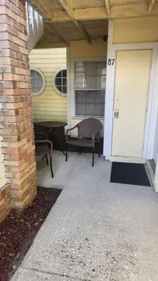 a front porch of a house with a white door at Disney Area Condo at Laguna Bay Villas! in Kissimmee
