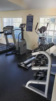 a gym with two tread machines and a treadmill at Disney Area Condo at Laguna Bay Villas! in Kissimmee