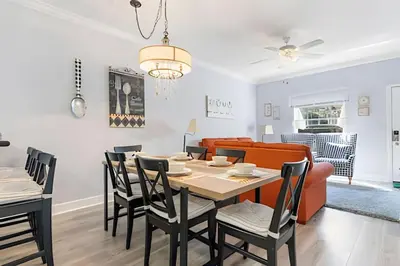 a dining room and living room with a table and chairs at Casa Moderna 3Q – Perto da Disney in Kissimmee