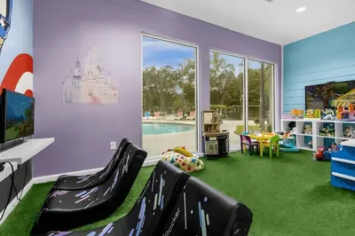 a childs play room with a castle on the floor at Casa 4Q c/ Clubhouse – 10 Min da Disney in Kissimmee