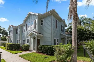 a house with a palm tree in front of it at Casa 4Q c/ Clubhouse – 10 Min da Disney in Kissimmee
