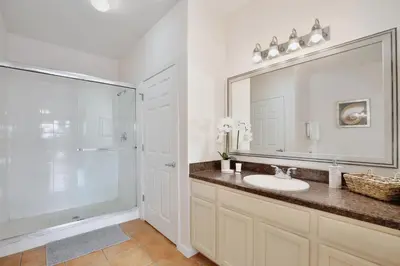 a bathroom with a sink and a shower and a mirror at New in the market apt with big terrace! in Orlando