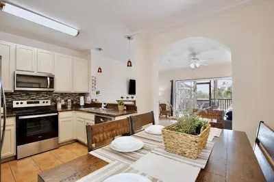 a kitchen and dining room with a table and chairs at New in the market apt with big terrace! in Orlando