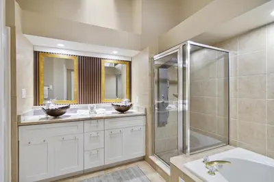 a bathroom with two sinks and a shower at Fascinating Private Pool And Game-Room, Near Disney!! in Kissimmee
