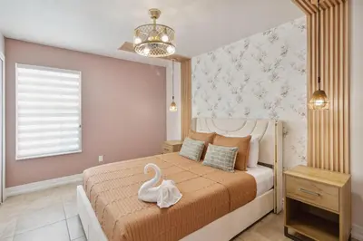 a bedroom with a bed with a swan on it at Fascinating Private Pool And Game-Room, Near Disney!! in Kissimmee