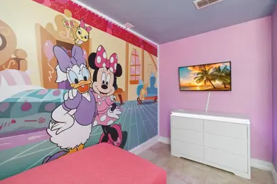 a bedroom with a mickey mouse mural on the wall at Fascinating Private Pool And Game-Room, Near Disney!! in Kissimmee