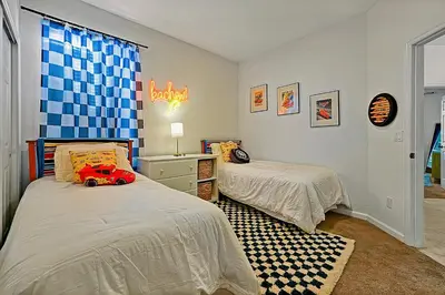 a bedroom with two beds and a toy car on the bed at Splash, Play, with a Disney Stay in Orlando