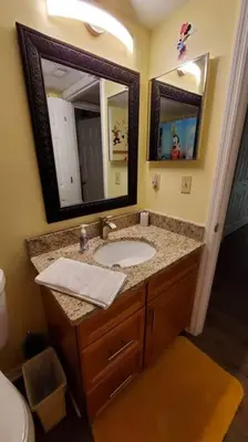 a bathroom with a sink and a mirror at Laguna Bay Villas - Disney Area Condo in Kissimmee