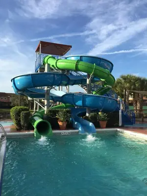 a water slide in a pool at a resort at Four Bedroom Townhouse in Regal Oaks at Old Town in Orlando