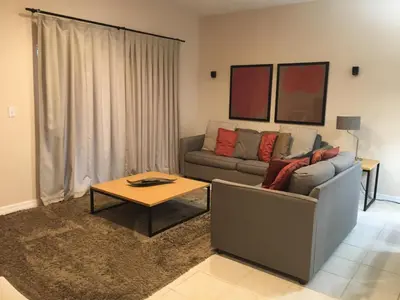 a living room with a couch and a coffee table at Four Bedroom Townhouse in Regal Oaks at Old Town in Orlando