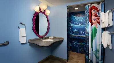 a bathroom with a sink and a mirror at Disney's Art Of Animation Resort in Orlando