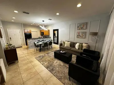 a living room with a couch and a table at 2BR Townhouse Near Disney in Kissimmee