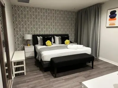 a bedroom with a large bed with yellow pillows at 2BR Townhouse Near Disney in Kissimmee