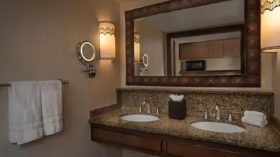 a bathroom with two sinks and a large mirror at Disney's Animal Kingdom Villas - Jambo House in Orlando